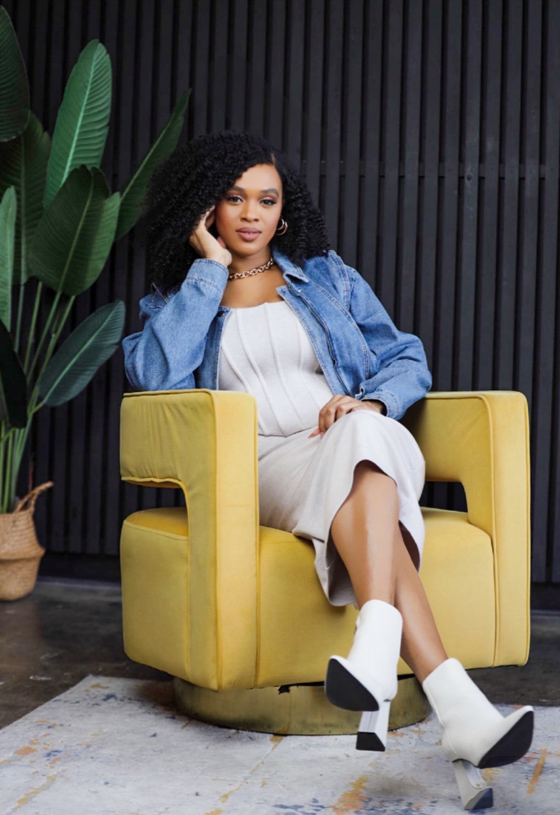 Imani, founder of Exalt The Light, seated in a golden velvet chair